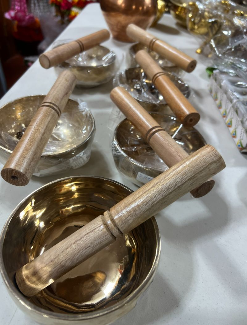 A table with many bowls and wooden handles.