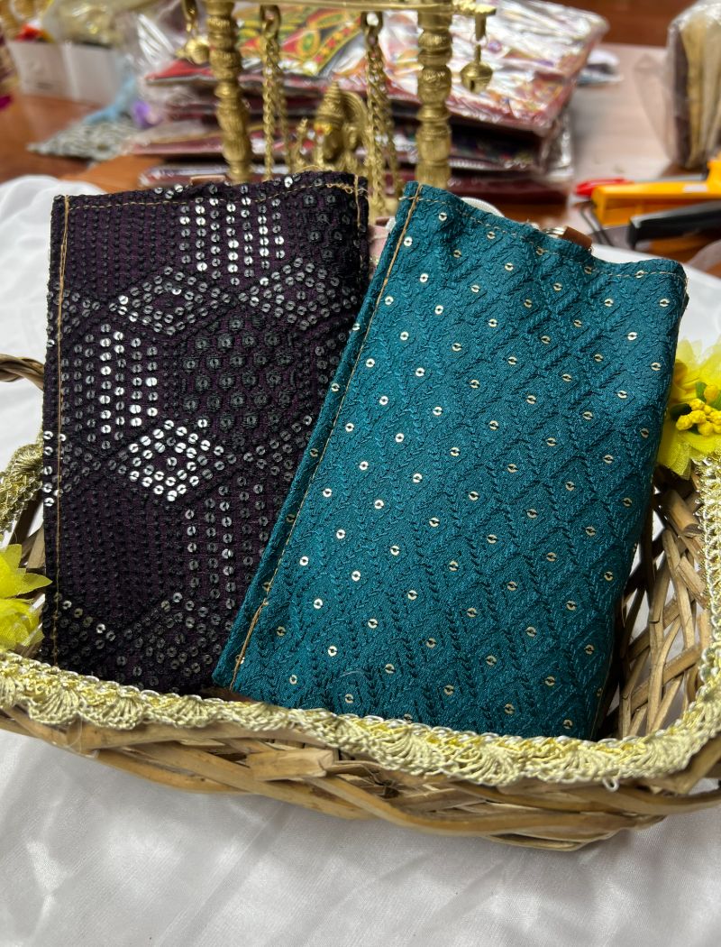 A basket with two different colored fabric covers.