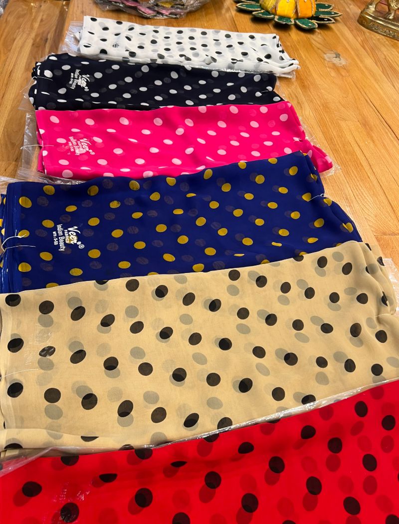 A group of polka dot scarves sitting on top of a wooden floor.