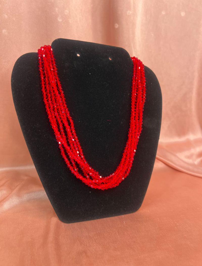 A black stand with red beads on it