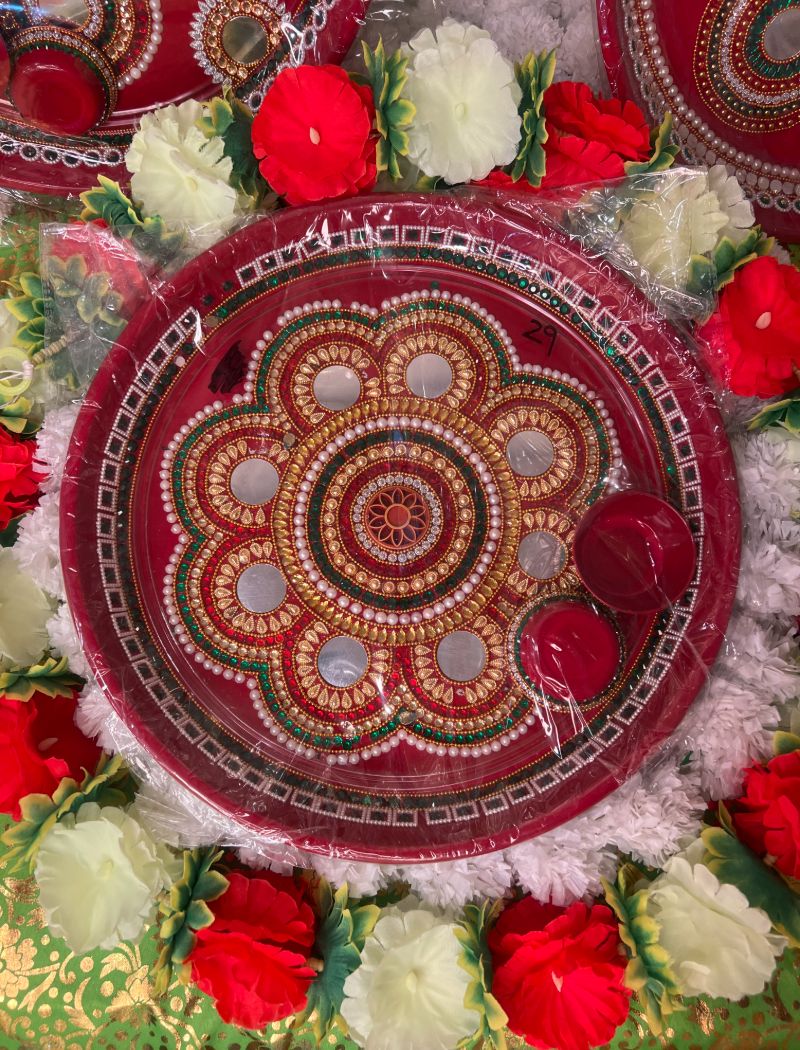 A close up of a bowl with flowers around it