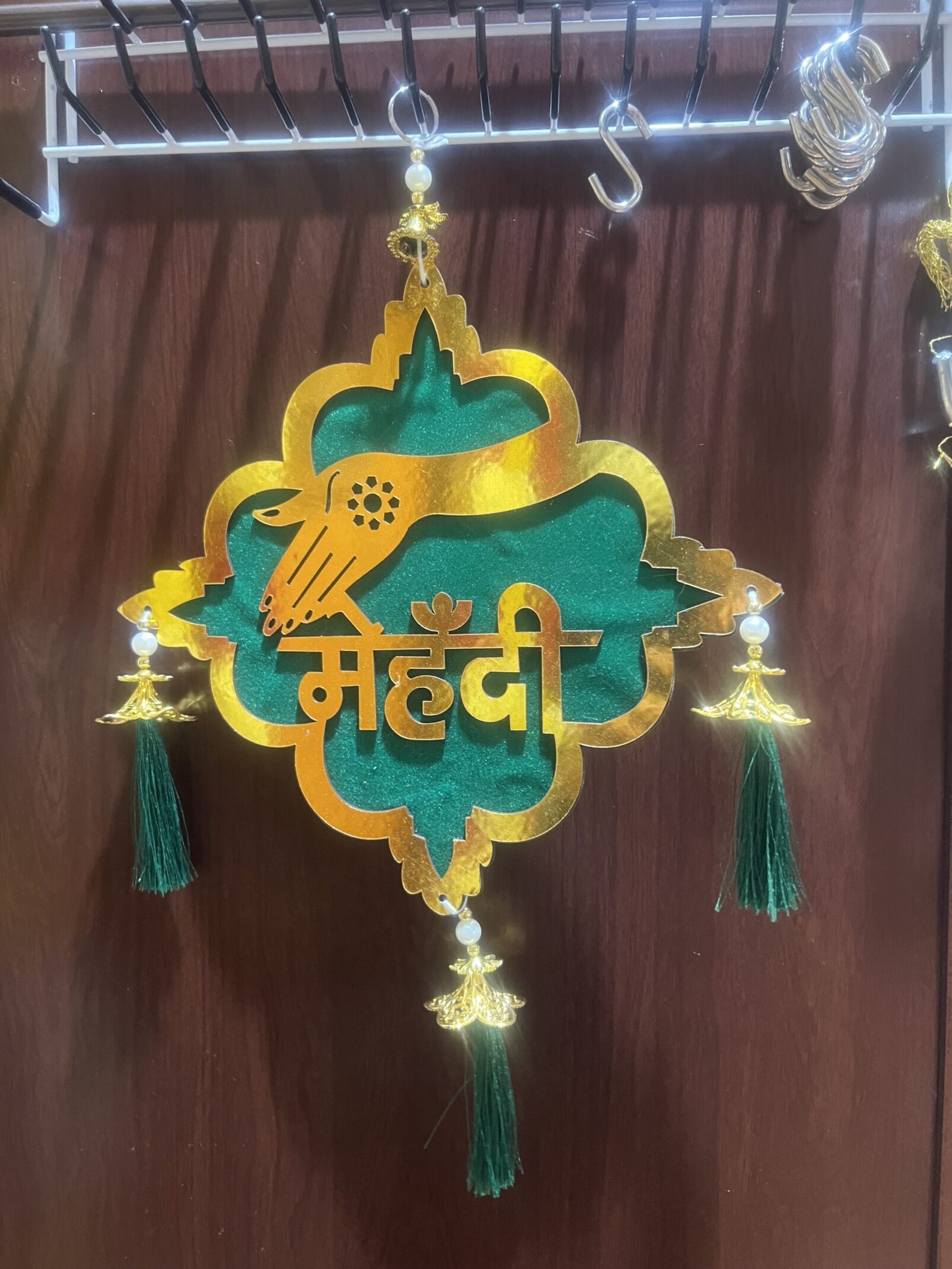 A green and yellow hanging decoration with tassels.