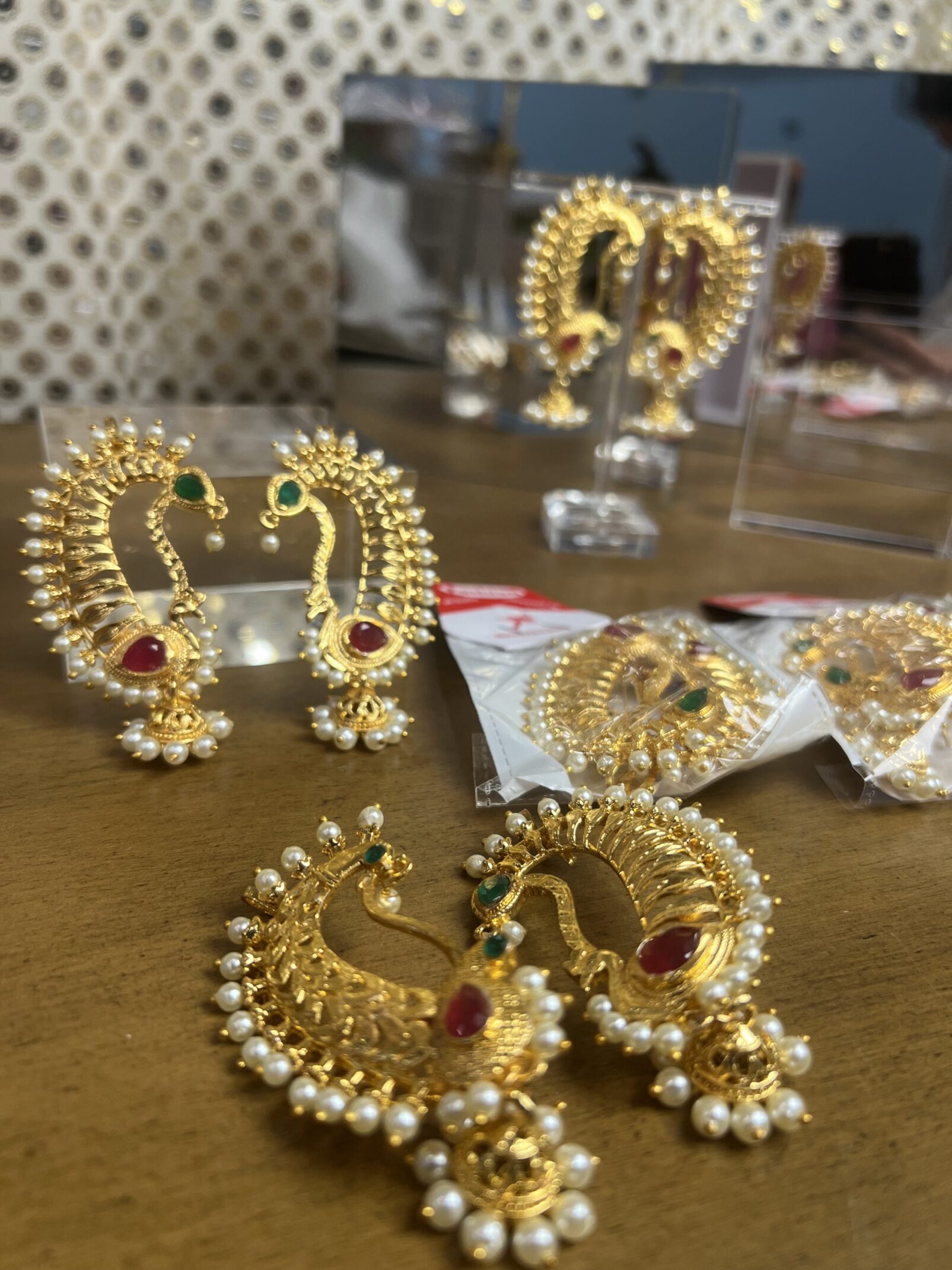 A table with some gold earrings on it