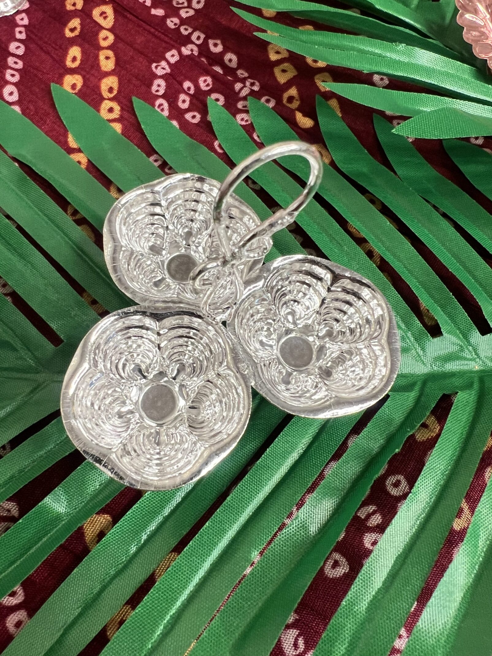 A close up of three bowls on top of a leaf