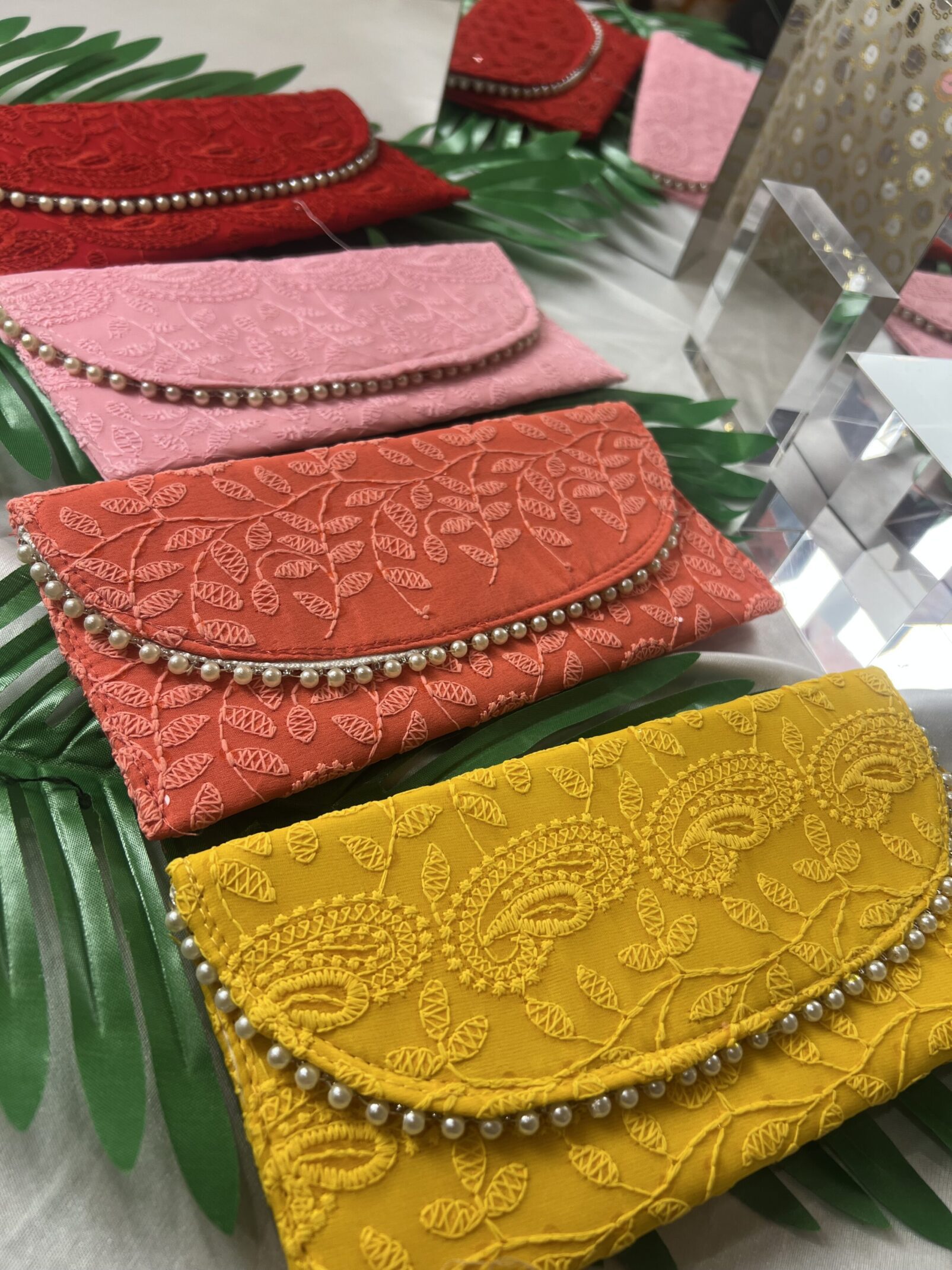 A group of four clutches sitting on top of a table.