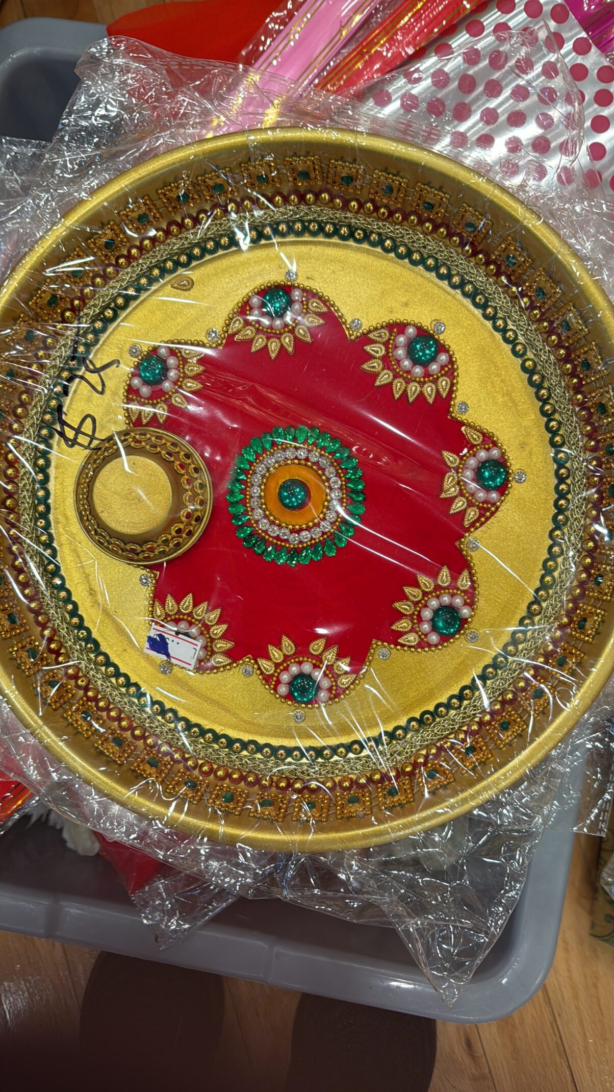 A yellow plate with red and green flowers on it