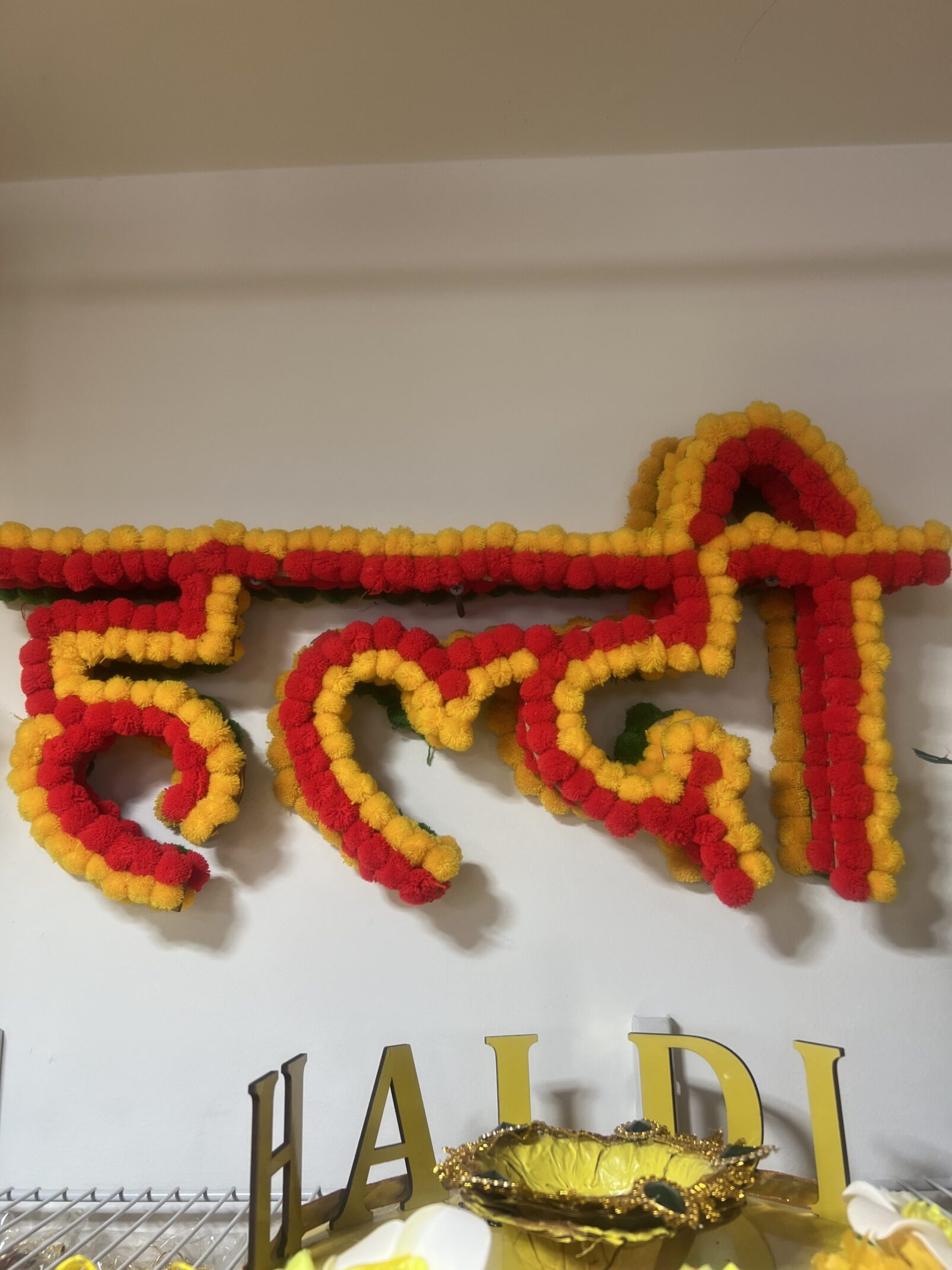 A sign that is made of yellow and red paper.