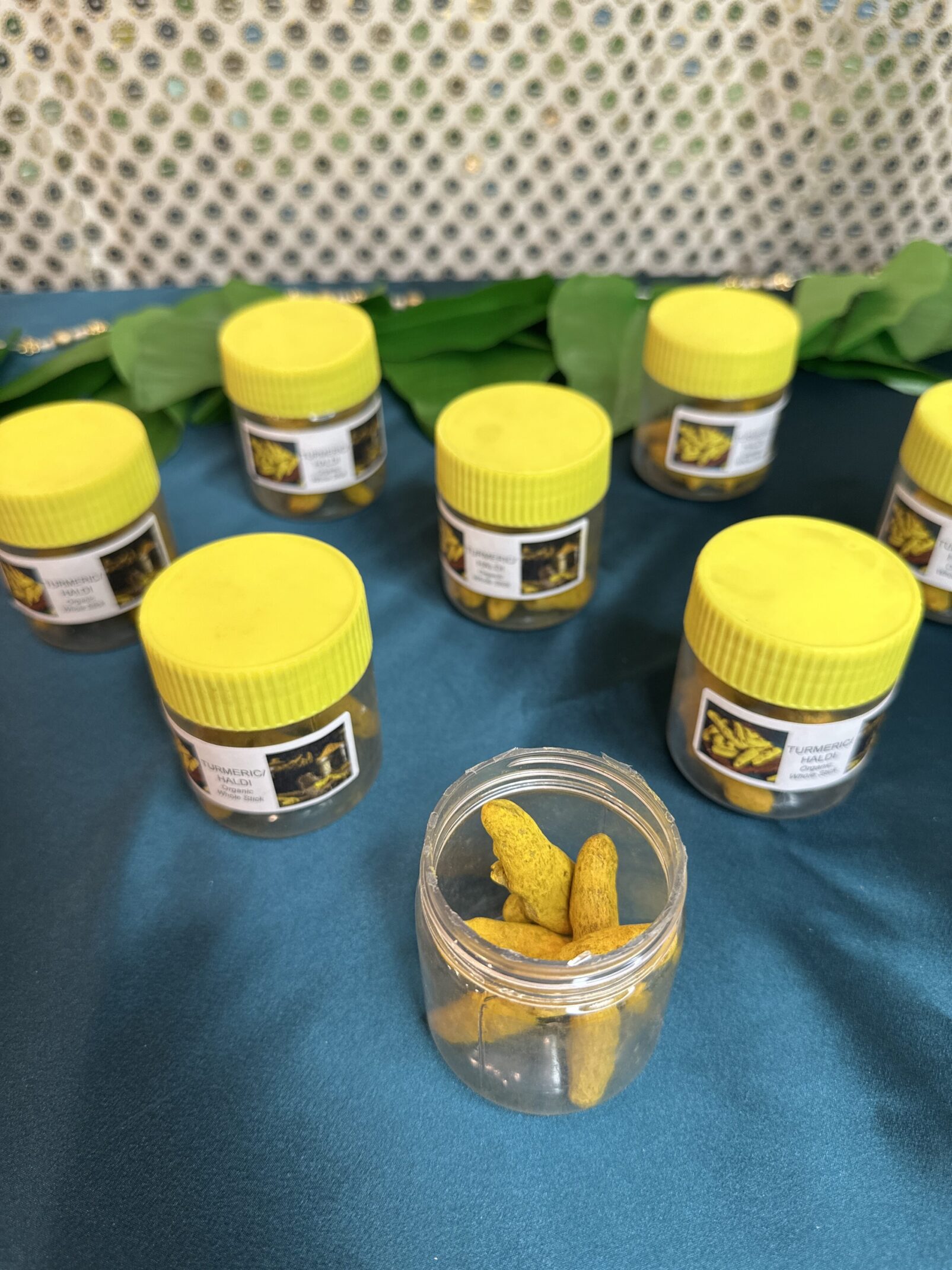 A group of jars filled with yellow food.