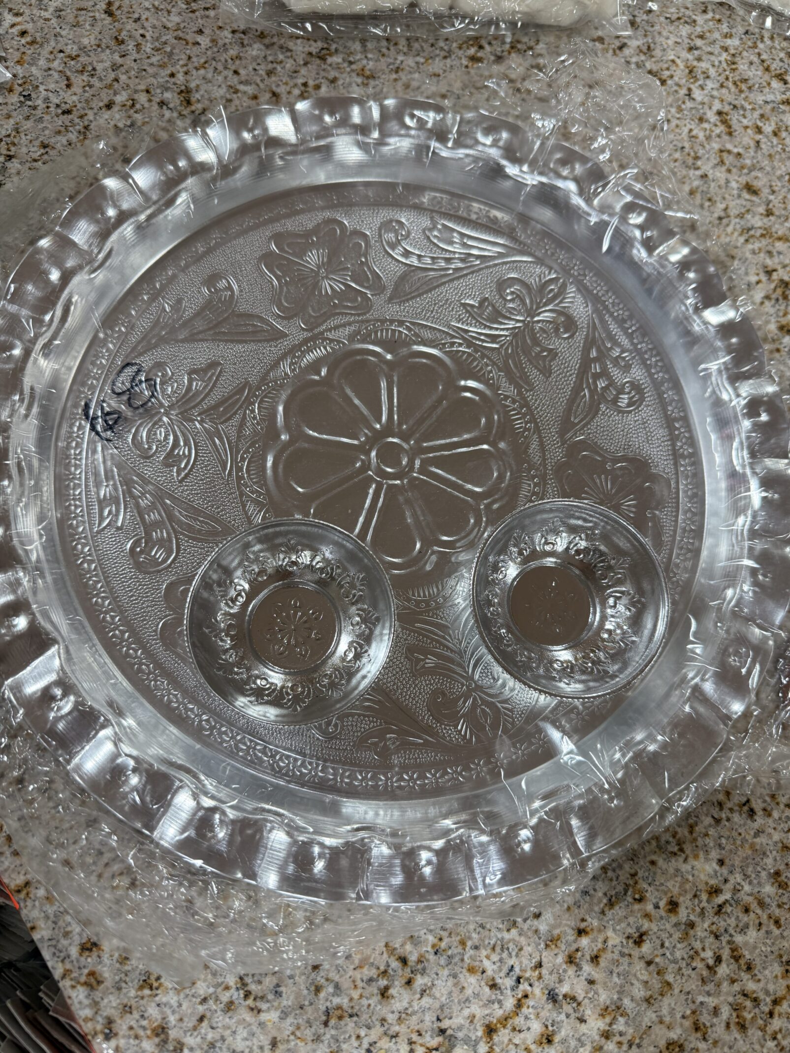 A glass plate with two candle holders on top of it.