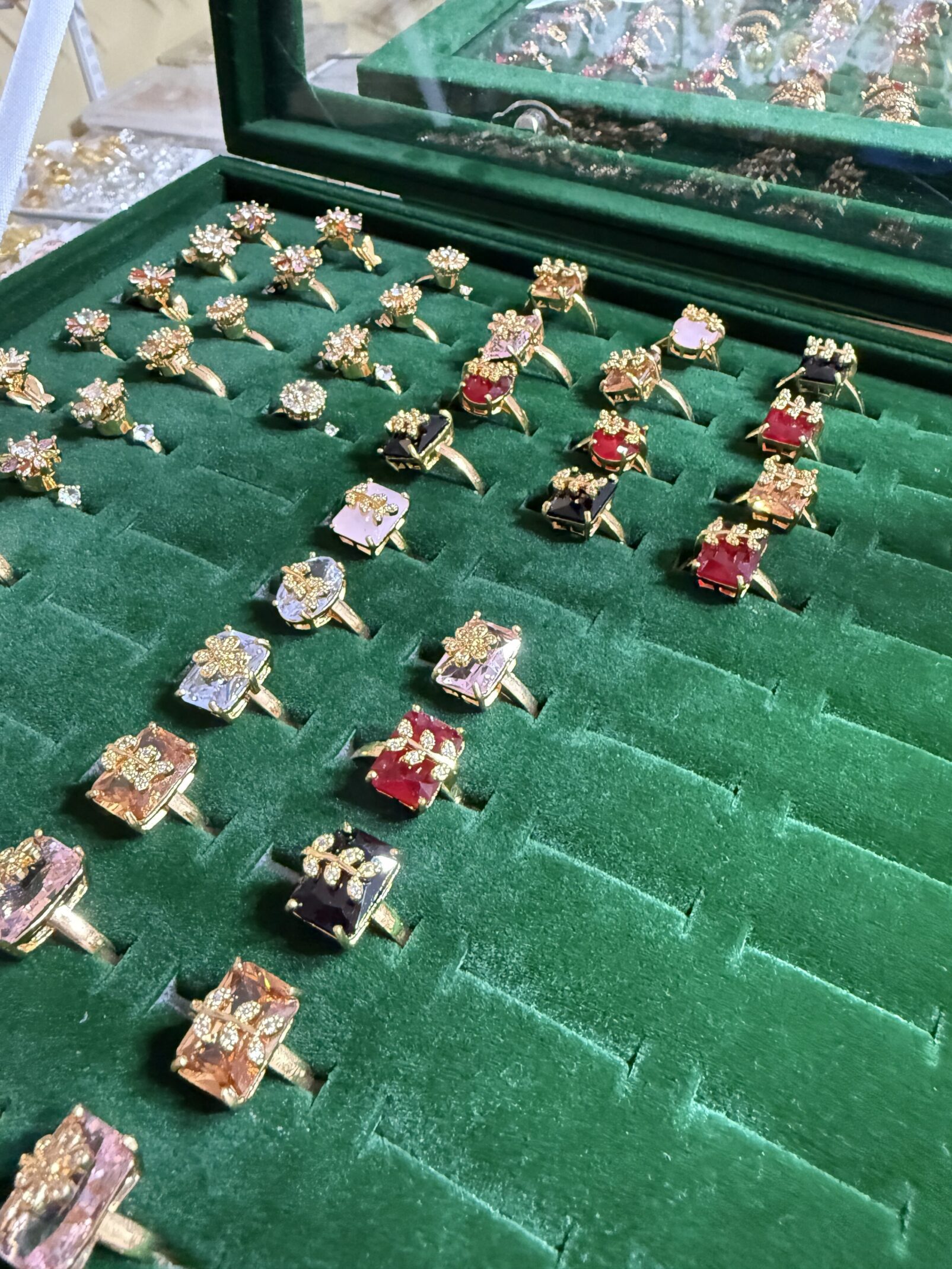 A green tray with many different rings on it
