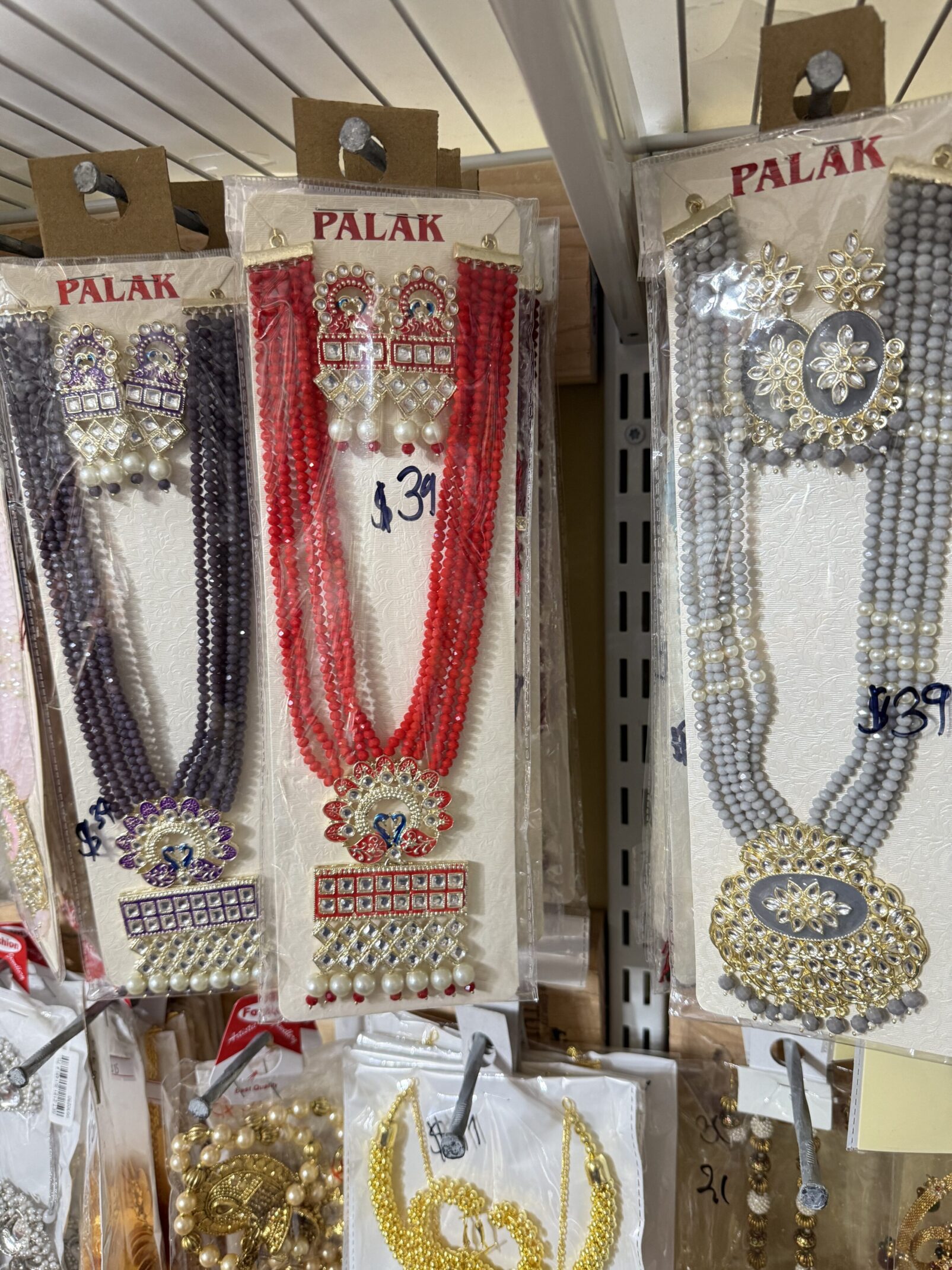 A display of necklaces and earrings in different colors.