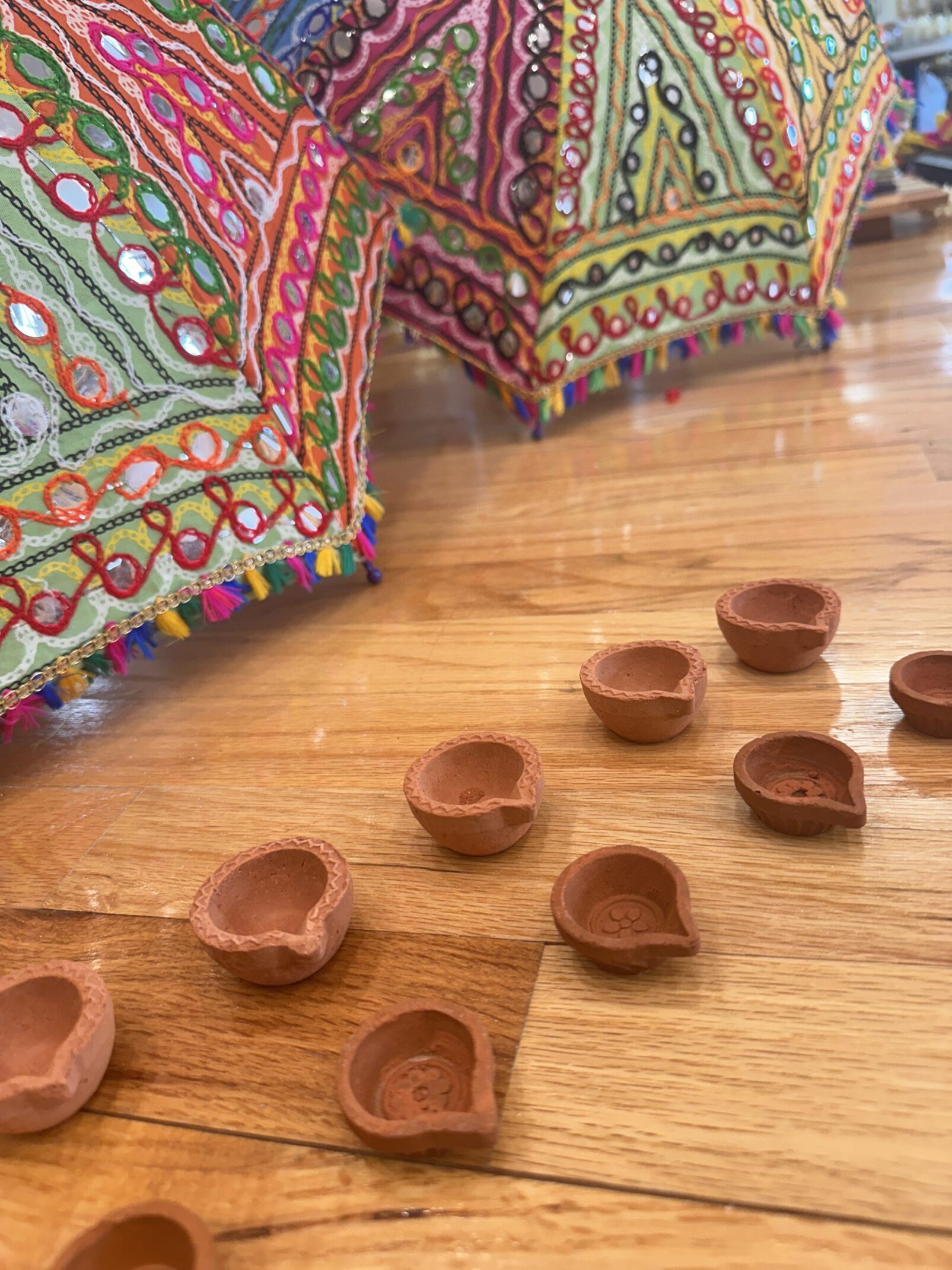 A wooden floor with some small clay bowls