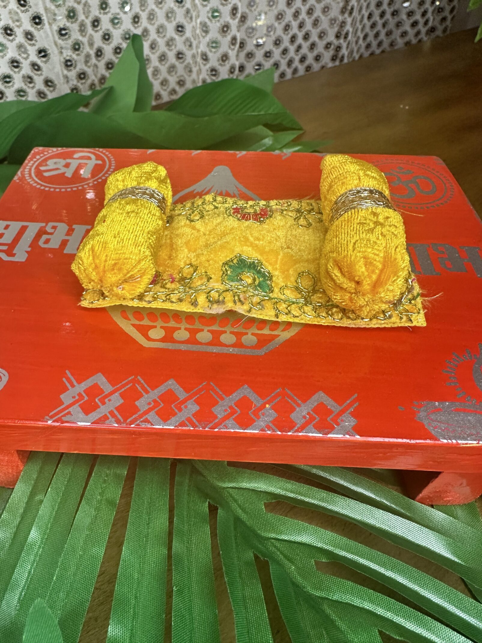 A red tray with some yellow food on it