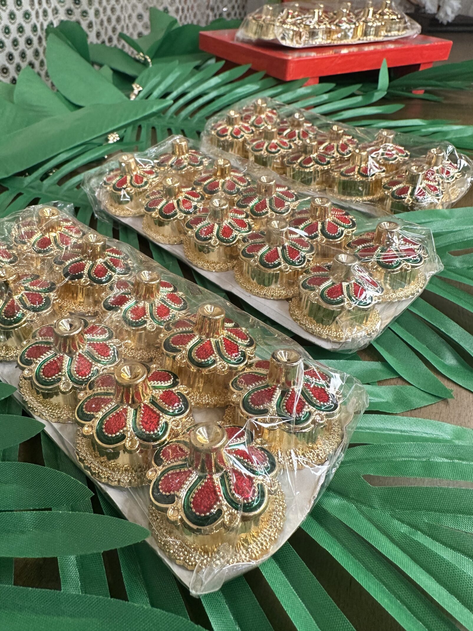 A couple of trays filled with food on top of green leaves.