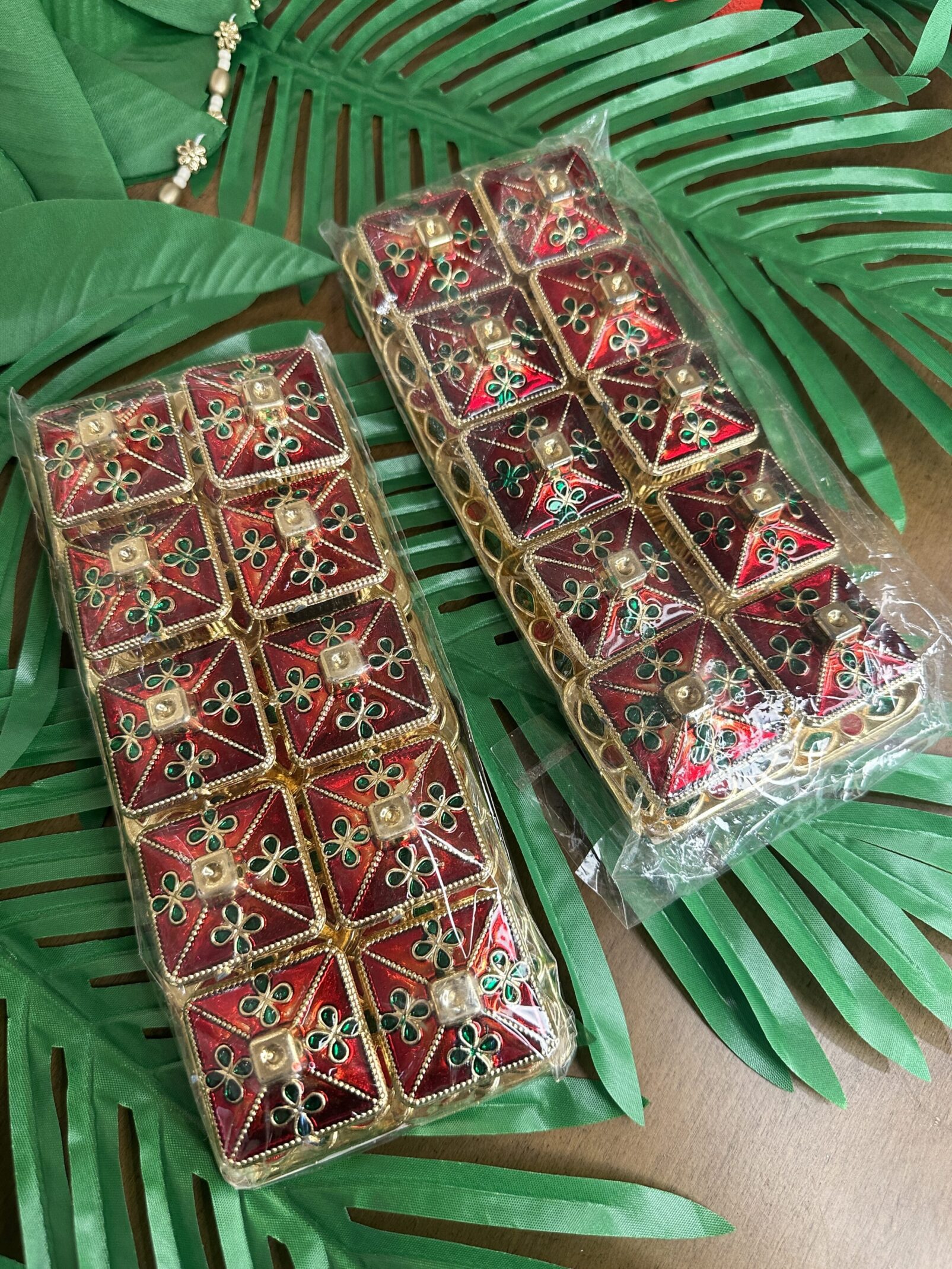 Two packages of cookies sitting on top of a leaf.