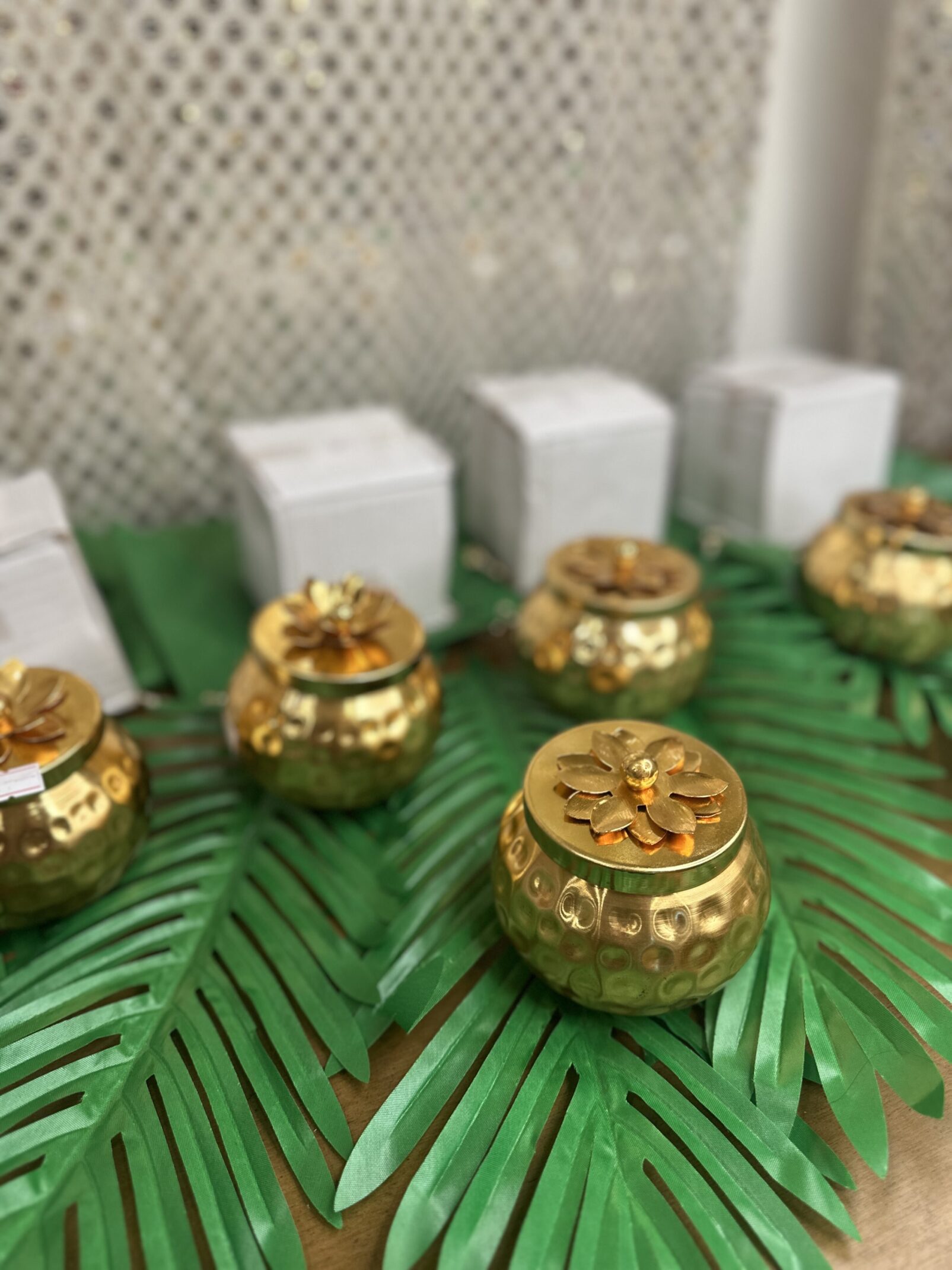 A close up of some candles on top of palm leaves