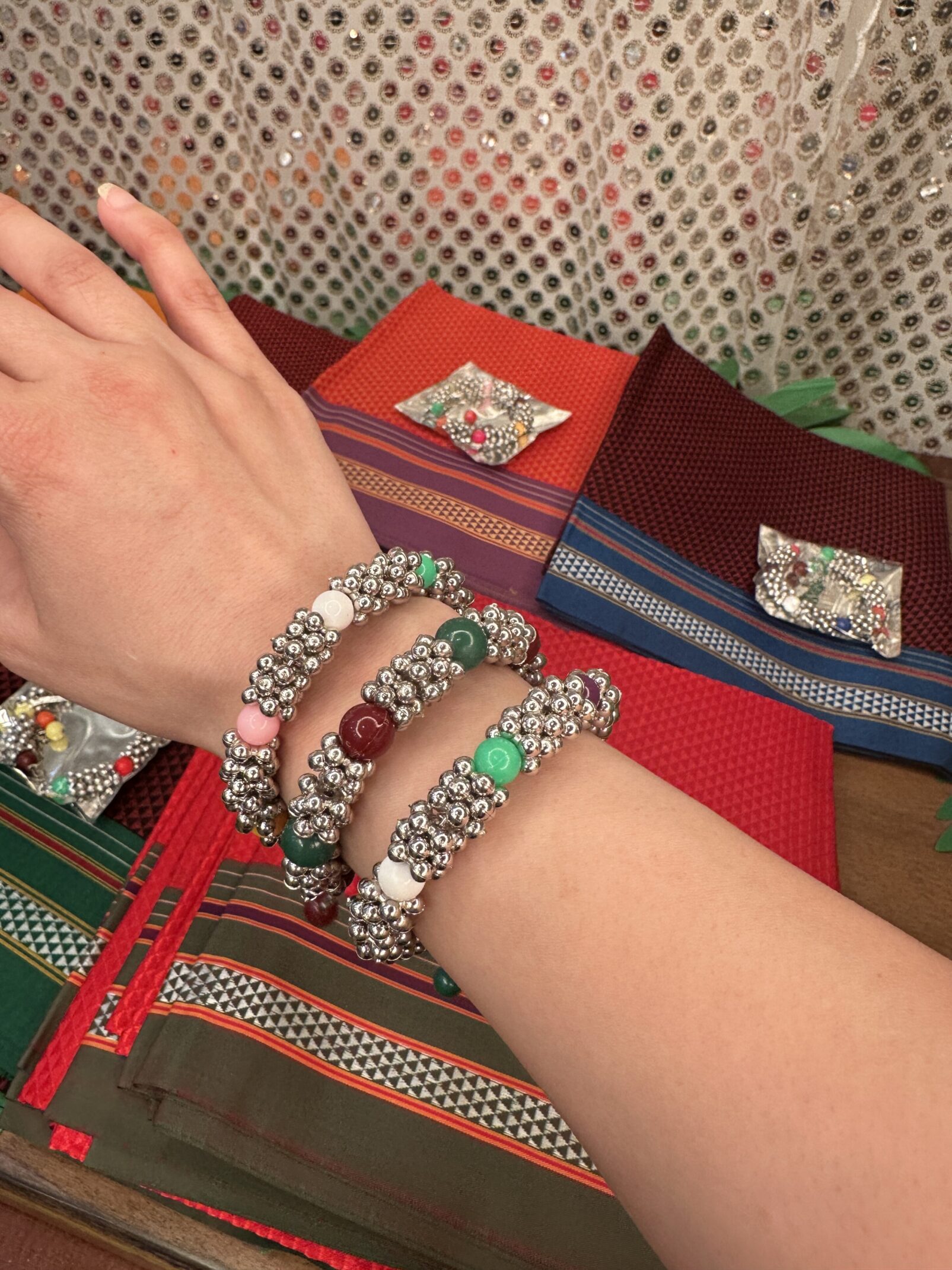 A woman 's hands are shown with bracelets.
