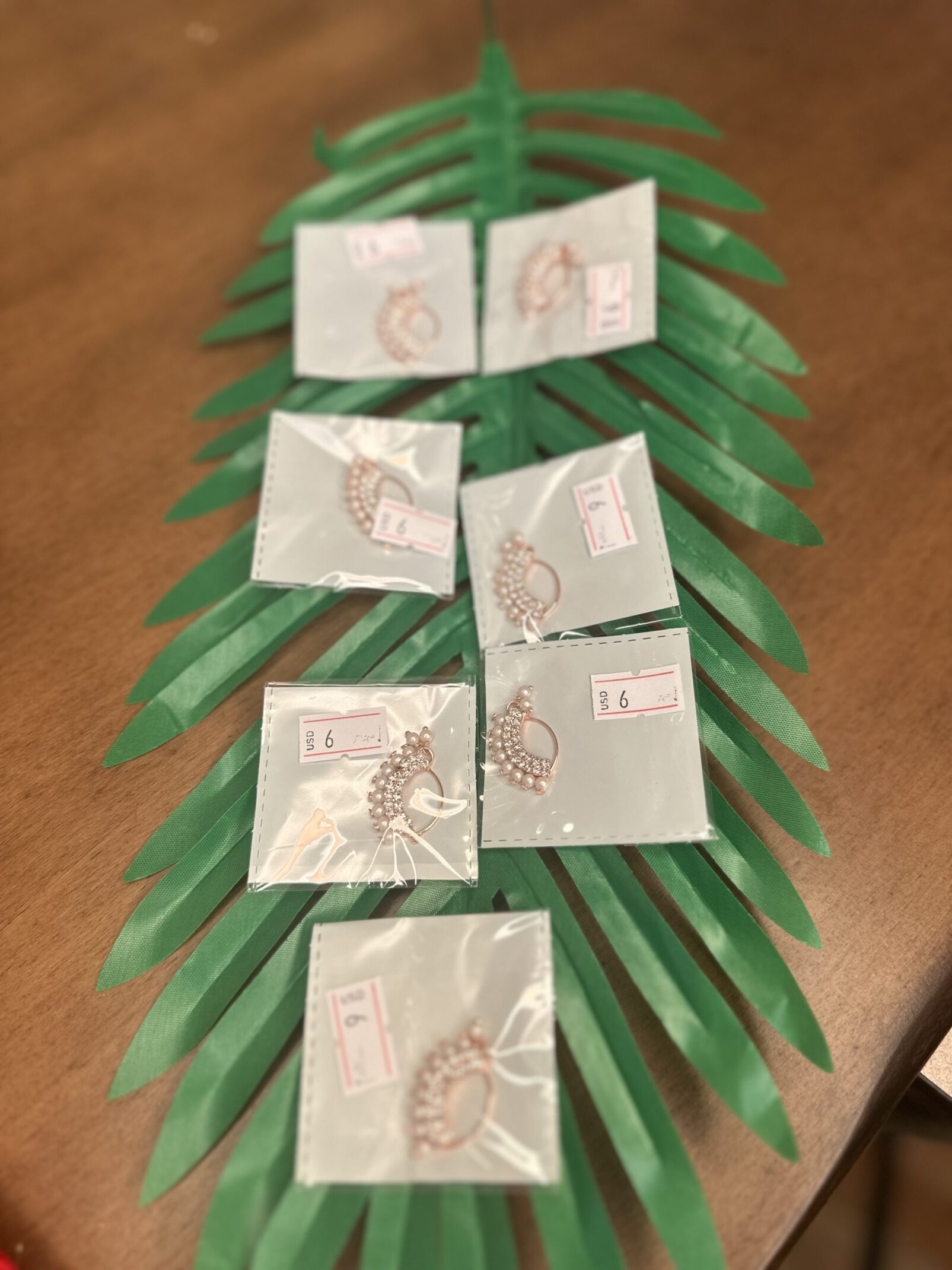 A table with some green leaves and many cards