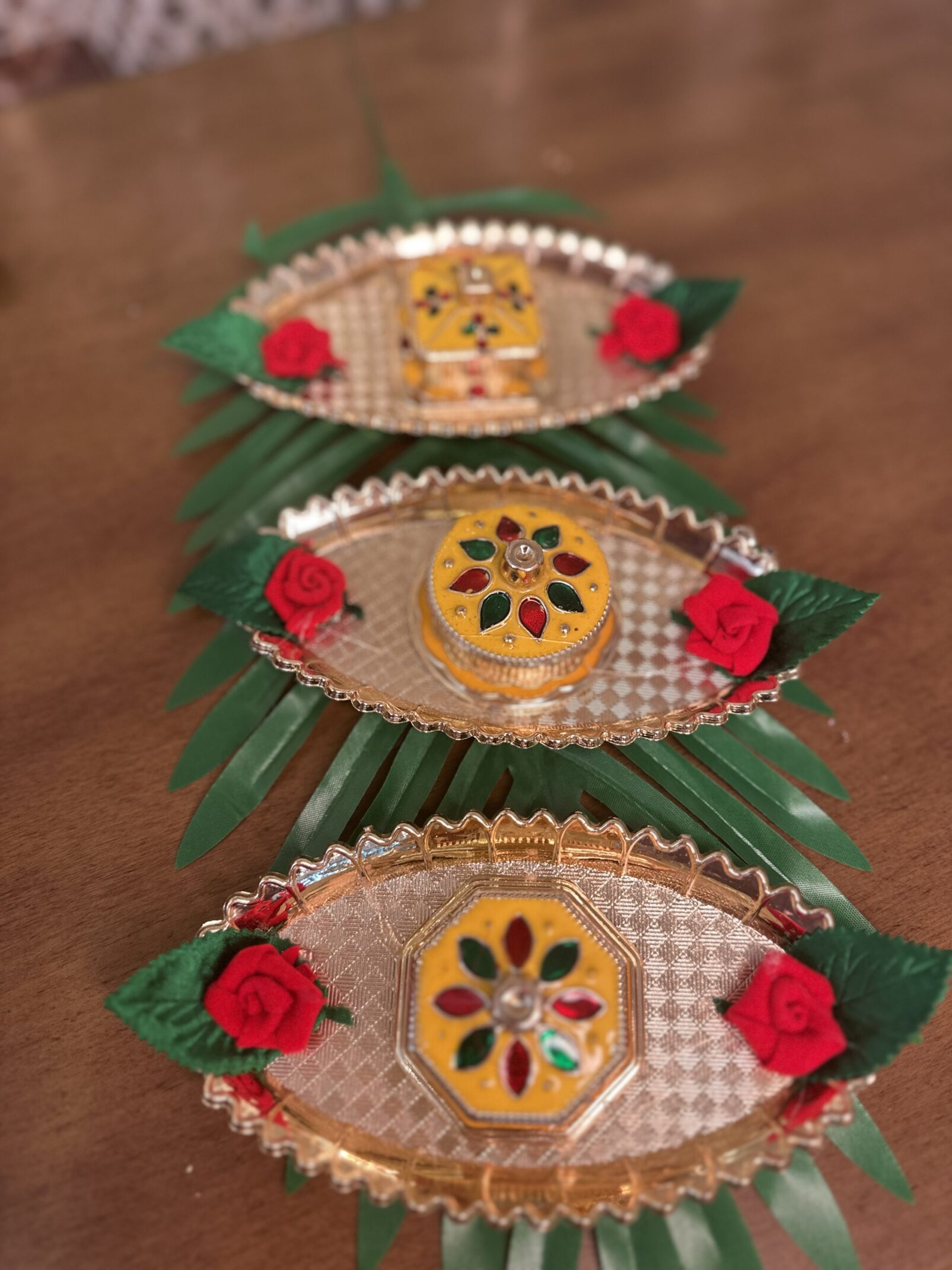 Three small trays with a flower design on them.