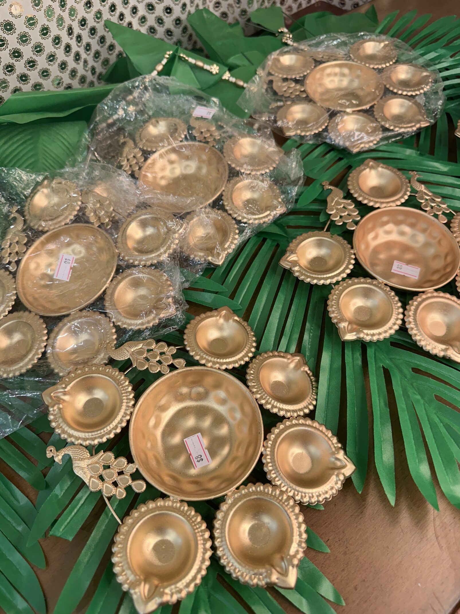 A table with green leaves and gold plates
