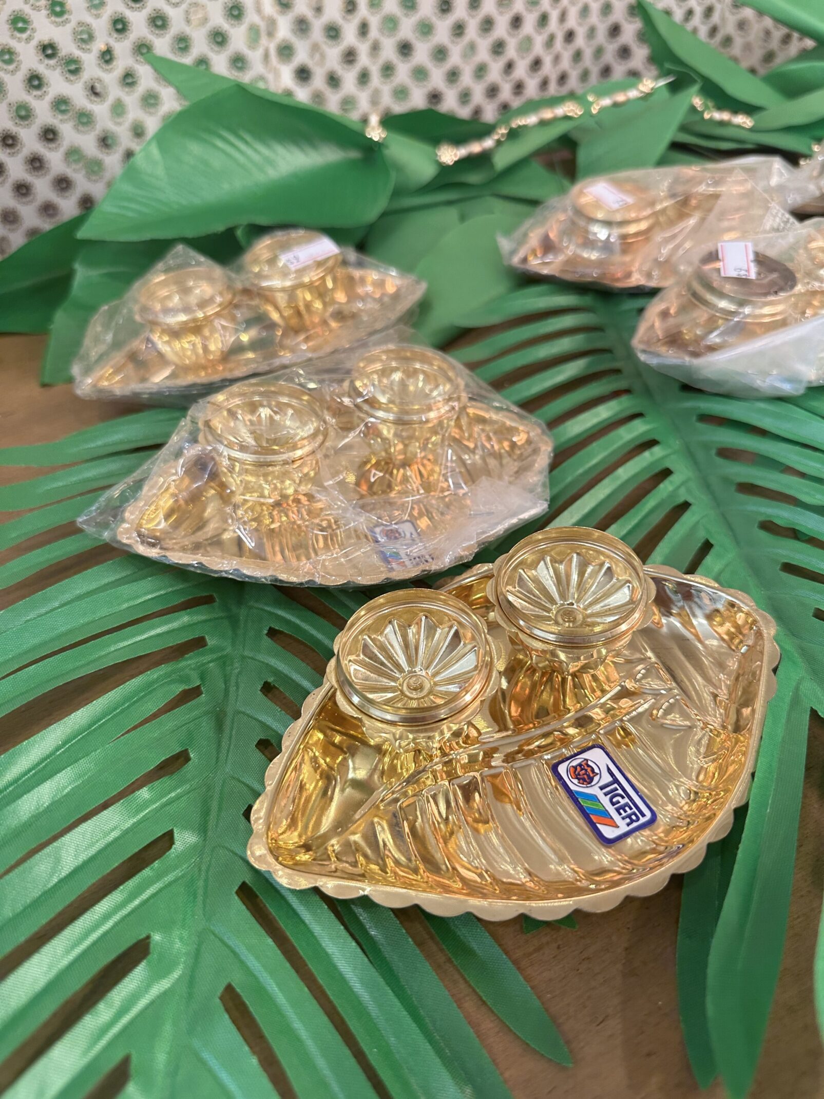 A table with palm leaves and gold dishes